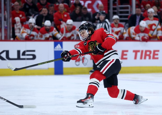 Blackhawks center Connor Bedard takes a shot in the first period against the Flames on March 26, 2024, at the United Center. (Chris Sweda/Chicago Tribune)