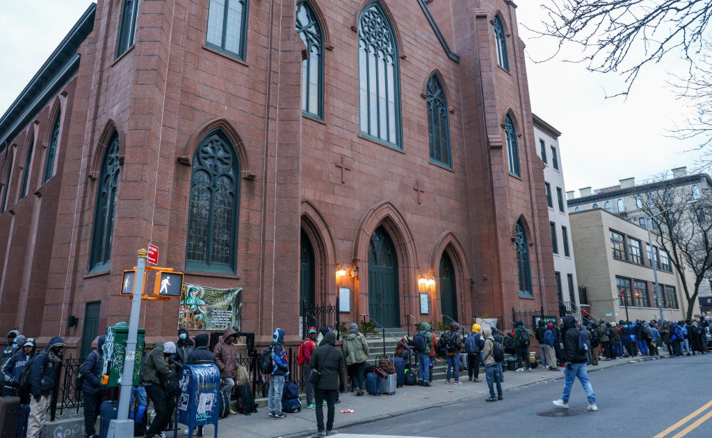 Recently arrived migrants line up outside the city's reticketing site for shelter and transportation at the St. Brigid's church in the East Village on Jan. 3, 2024.