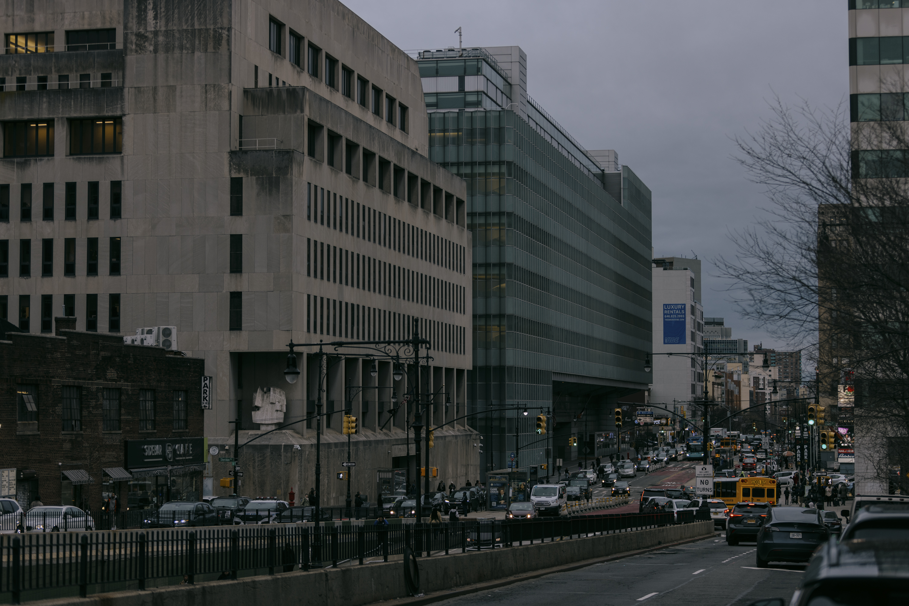 View of a Bronx street, showing cars and the Bronx County Hall Of Justice in the background.