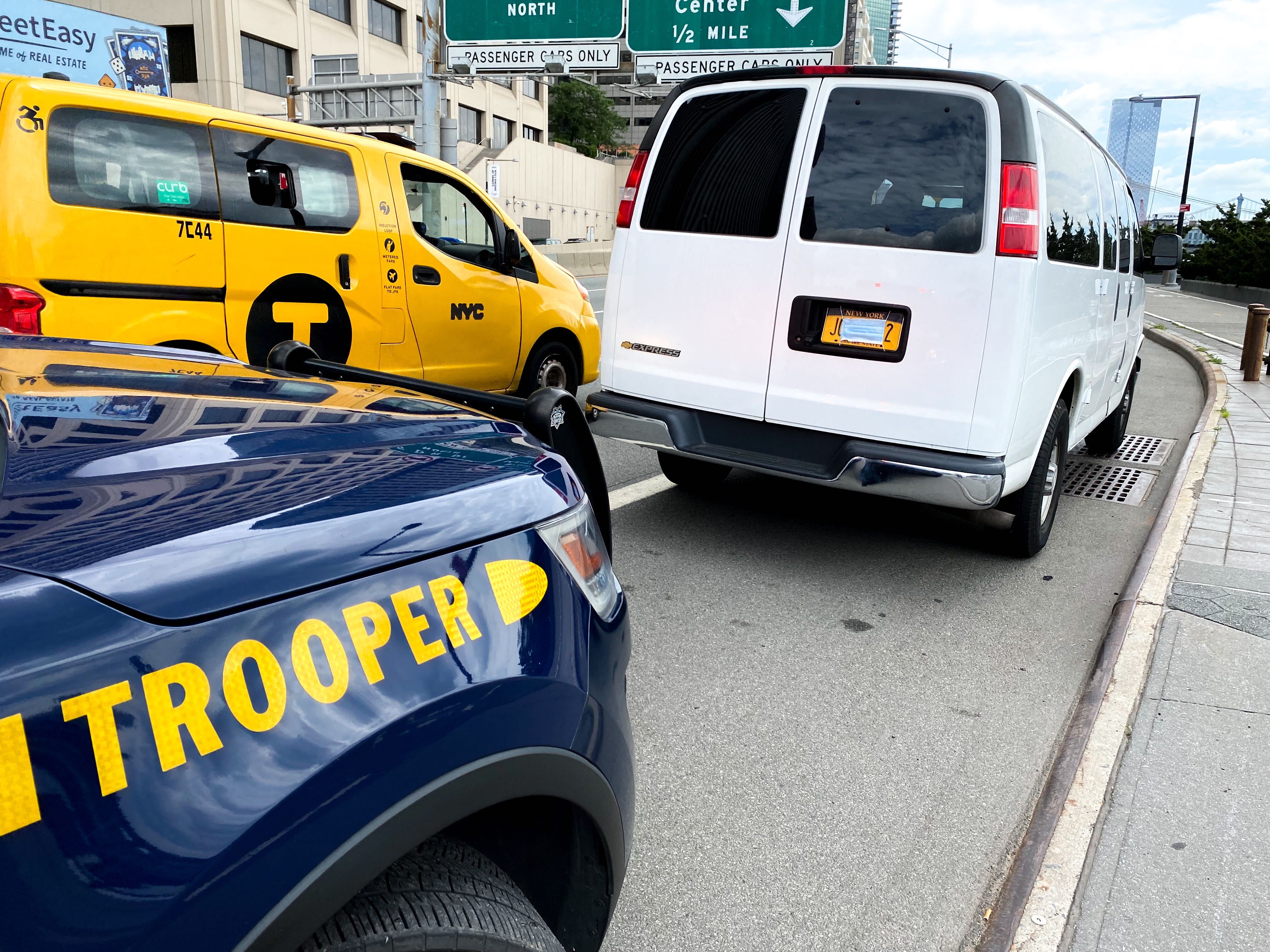 A photo of a vehicle with obscured plates driven by NYPD officers