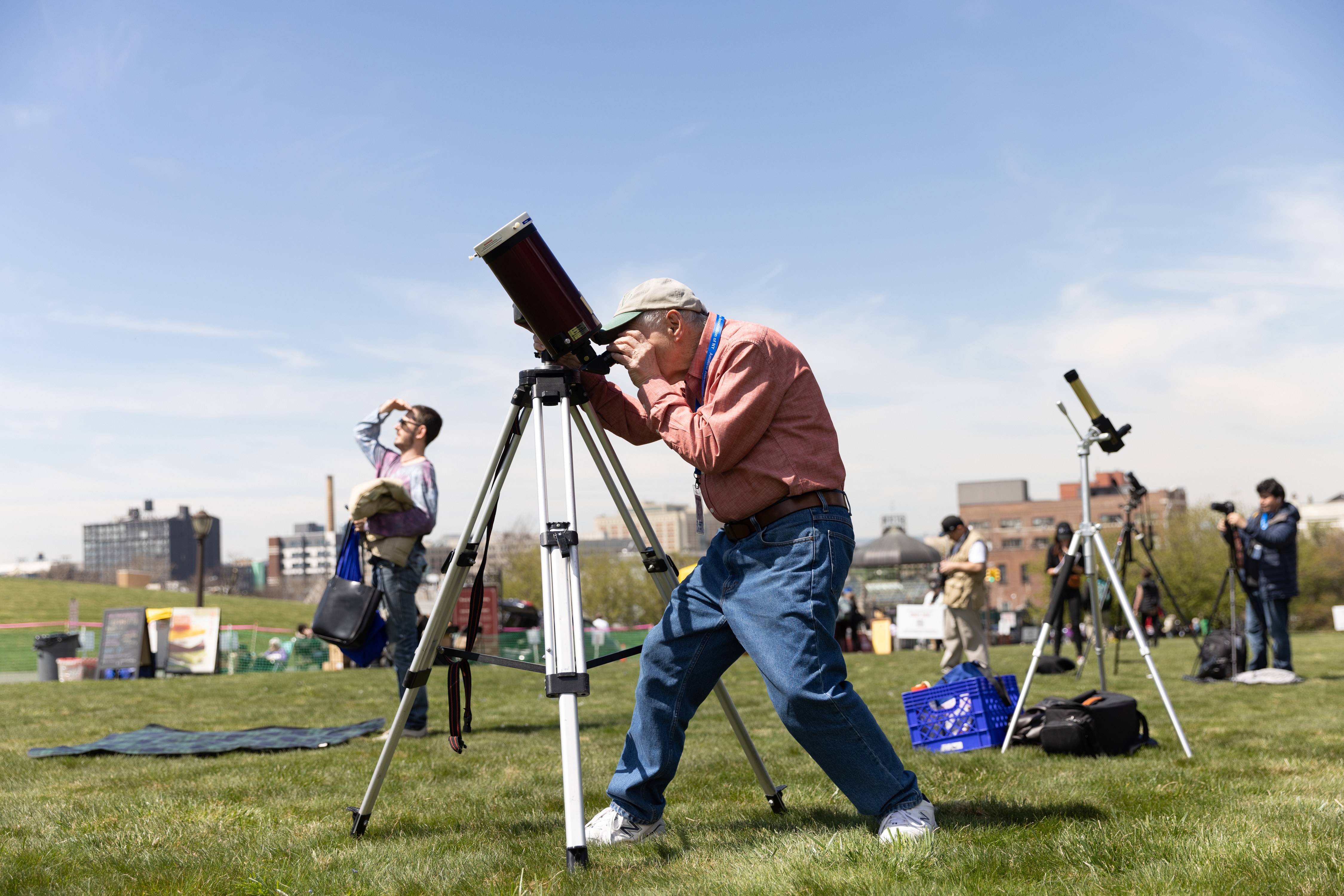 Joe Delfausse from the Amateur Astronomers Association sets up his telescope for the solar eclipse at Greenwood Cemetery in Brooklyn, New York on April 8, 2023.