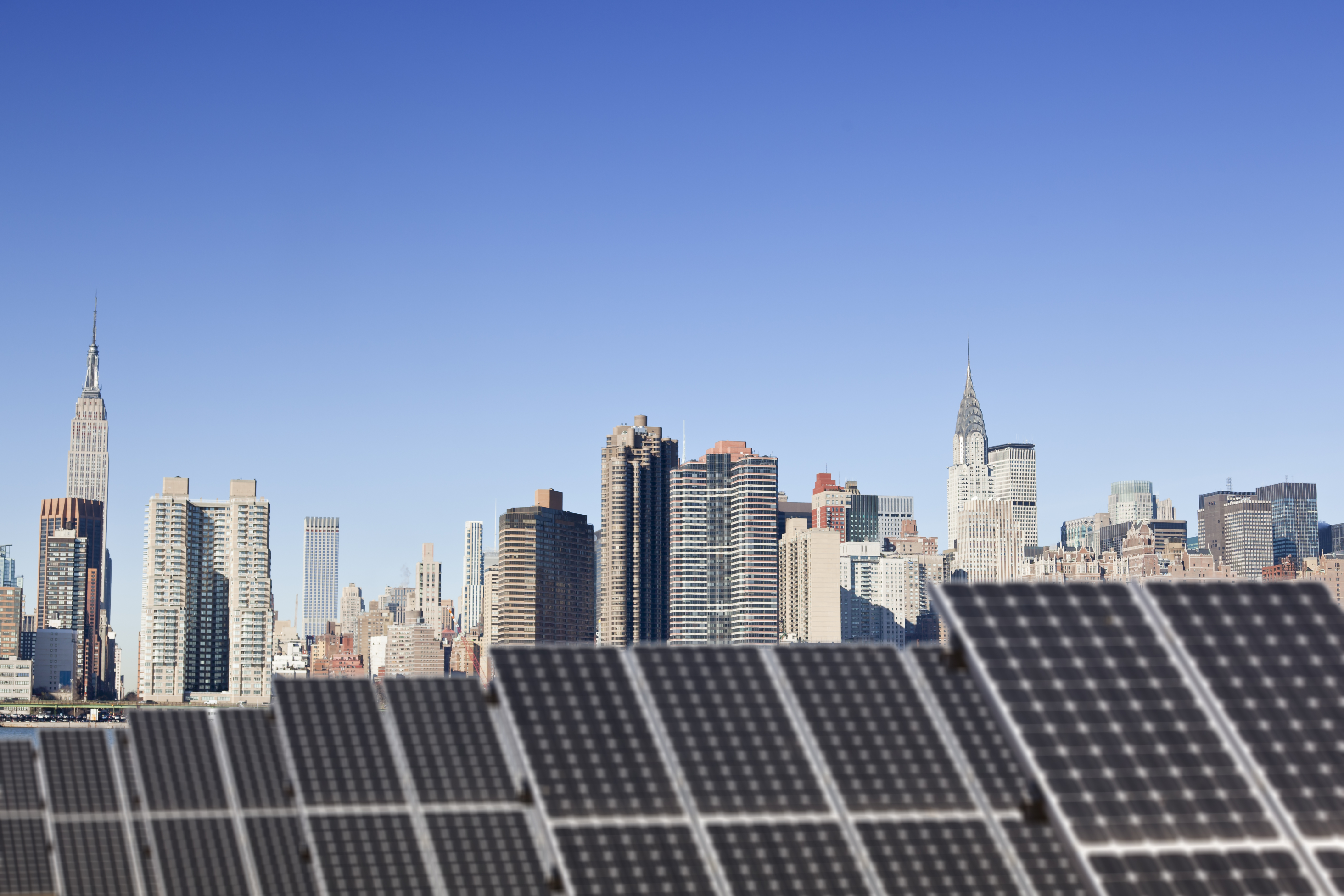 Solar panels with the New York City skyline in the background.