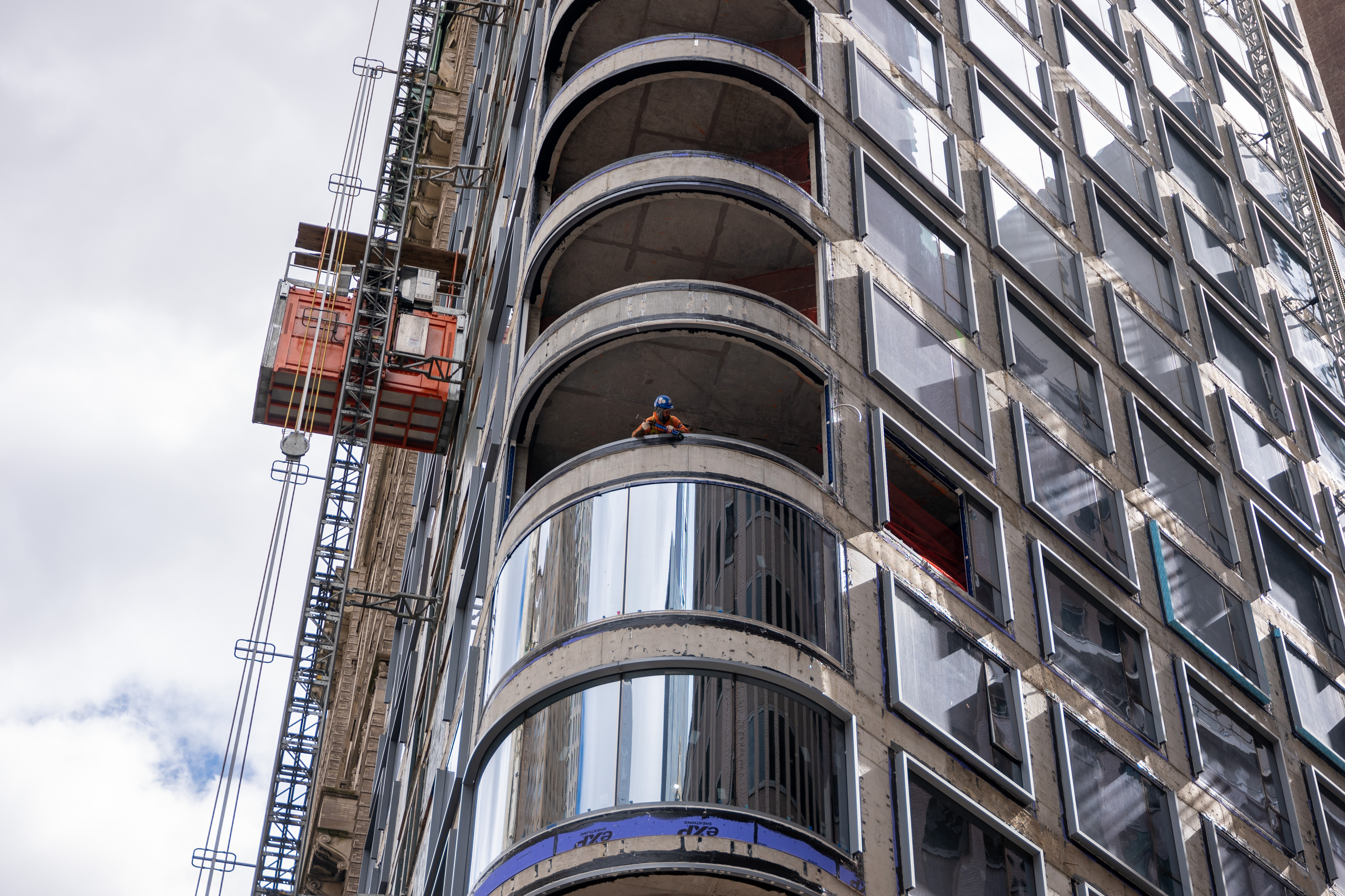 A worker peers out from a worksite in lower Manhattan moments after New York City and parts of New Jersey experienced an earthquake on April 05