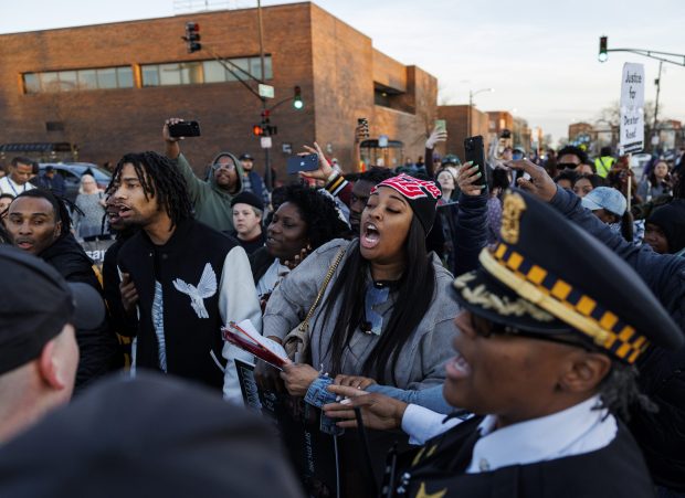 Dexter Reed's siblings Julius Reed, center left, and Porscha Banks, center, protest at CPD's Harrison District (11th) after the Civilian Office of Police Accountability released body camera video showing the fatal shooting of Reed, 26, who was killed March 21, in an "exchange of gunfire" with officers on April 9, 2024, in Chicago. (Armando L. Sanchez/Chicago Tribune)