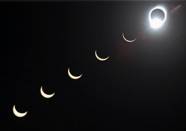 The progression of a total solar eclipse is seen in a multiple exposure photograph taken in 5-minute intervals, with the moon passing in front of the sun above Siem Reap in northwestern Cambodia, 225 kilometers (140 miles) from Phnom Penh, on Tuesday, Oct. 24, 1995. (AP Photo/Richard Vogel, File)