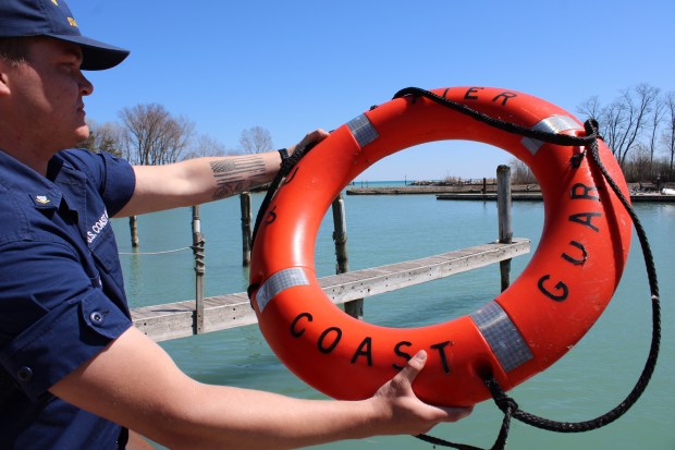 U.S. Coast Guard Petty Officer Ben Carter does a safety demonstration during the Wilmette Harbor U.S. Coast Guard Station open house on April 13. (Gina Grillo/Pioneer Press)