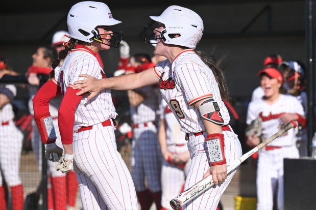 Andrean's Gracie Wardingley, on right, and Elizabeth Voliva celebrate after two runs were scored against Illiana Christian in the class 2A Illiana Christian Sectional championship game on Friday, May 26, 2023. (Kyle Telechan for the Post-Tribune)