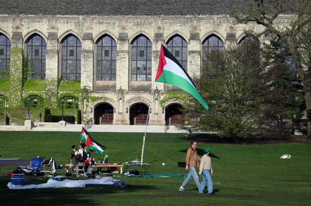 Deering Meadow, on Sheffield Road in Evanston, which was the center of pro-Palestinian demonstrations at Northwestern University, is largely empty on May 1, 2024, while hundreds of signs and banners still hang on the fence at the meadow's edge. (Terrence Antonio James/Chicago Tribune)