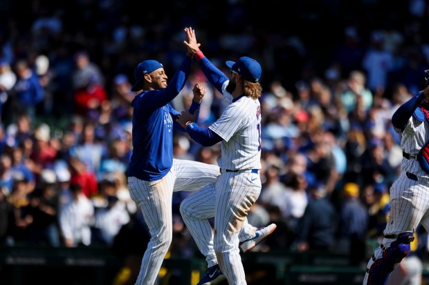 Chicago Cubs third base Christopher Morel (5) and Chicago Cubs outfielder Patrick Wisdom (16) celebrate after winning the game against the Milwaukee Brewers at Wrigley Field on May 5, 2024. (Eileen T. Meslar/Chicago Tribune)