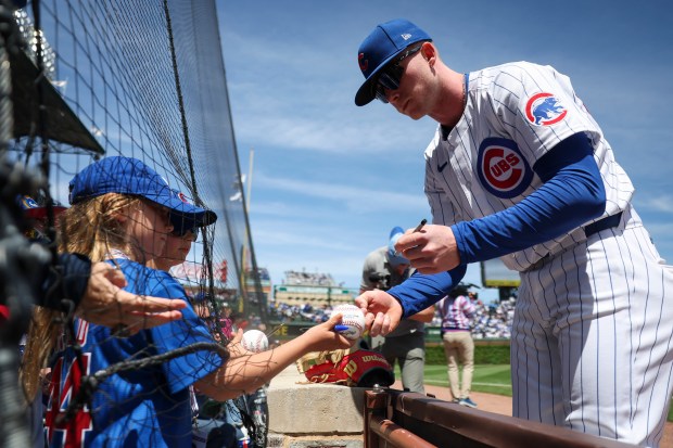Chicago Cubs outfielder Pete Crow-Armstrong (52) signs autographs for fans before the game against the Milwaukee Brewers at Wrigley Field on May 5, 2024. (Eileen T. Meslar/Chicago Tribune)