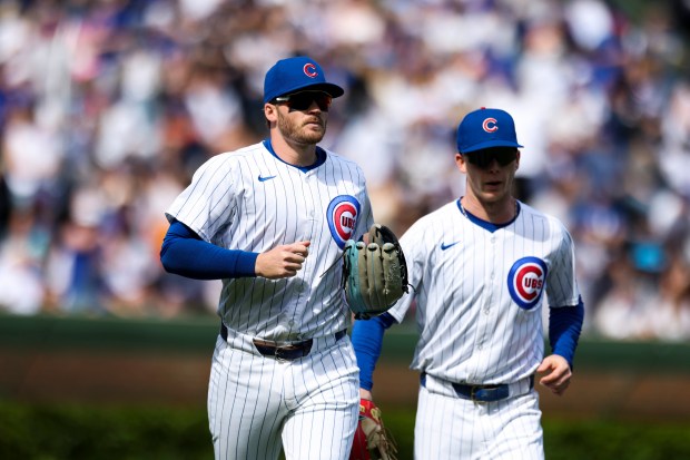 Chicago Cubs outfielder Ian Happ (8) and outfielder Pete Crow-Armstrong (52) run to the dugout after Happ caught a fly ball to end the top of the eighth inning against the Milwaukee Brewers at Wrigley Field on May 5, 2024. (Eileen T. Meslar/Chicago Tribune)