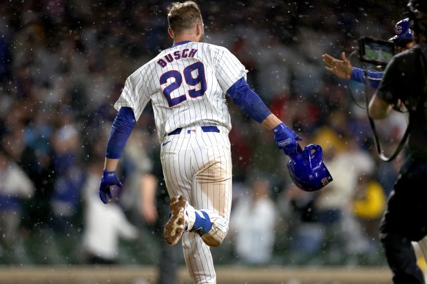 Chicago Cubs first baseman Michael Busch (29) celebrates as he rounds the bases after hitting a walk-off solo home run in the ninth inning of a game against the San Diego Padres at Wrigley Field in Chicago on May 7, 2024. (Chris Sweda/Chicago Tribune)