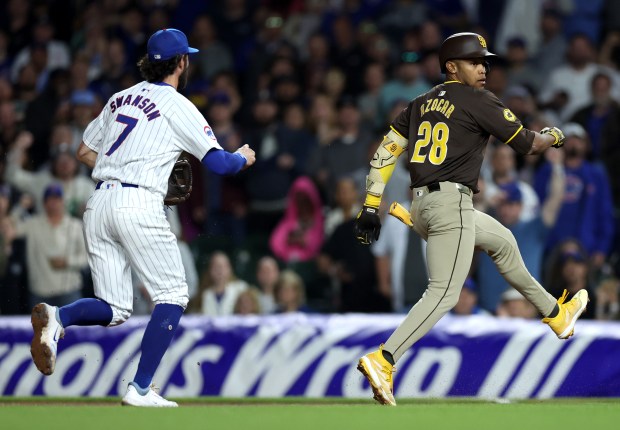 Chicago Cubs shortstop Dansby Swanson (7) chases San Diego Padres baserunner José Azocar (28) before Azocar is tagged out while caught in a rundown to end the top of the seventh inning of a game at Wrigley Field in Chicago on May 7, 2024. (Chris Sweda/Chicago Tribune)