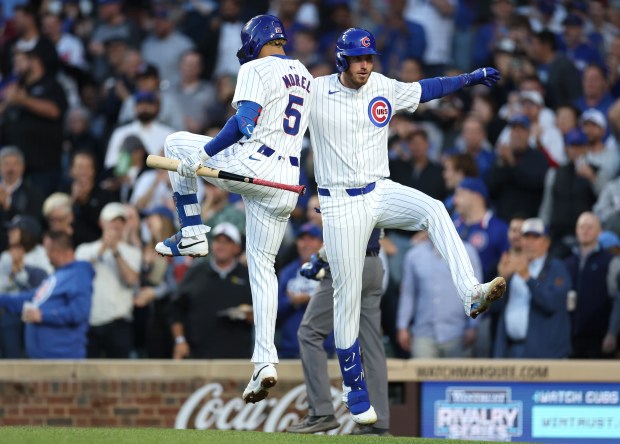Chicago Cubs designated hitter Cody Bellinger (right) celebrates with teammate Christopher Morel (5) after Bellinger hit a solo home run in the fourth inning of a game against the San Diego Padres at Wrigley Field in Chicago on May 7, 2024. (Chris Sweda/Chicago Tribune)