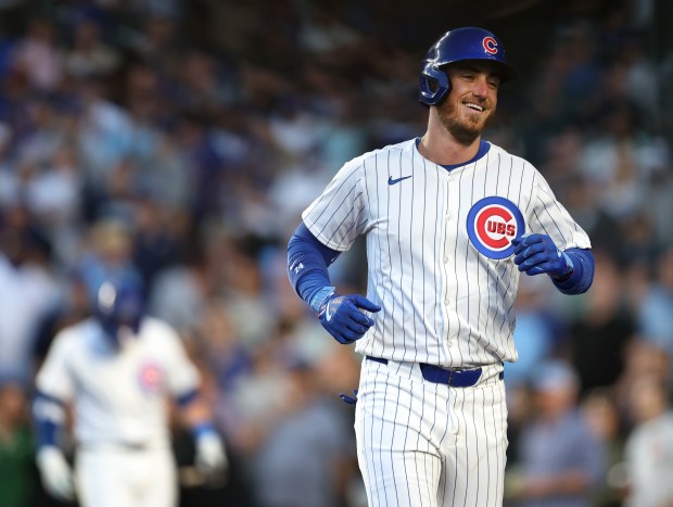 Chicago Cubs designated hitter Cody Bellinger has a laugh as he enters the dugout after hitting a solo home run in the fourth inning of a game against the San Diego Padres at Wrigley Field in Chicago on May 7, 2024. (Chris Sweda/Chicago Tribune)