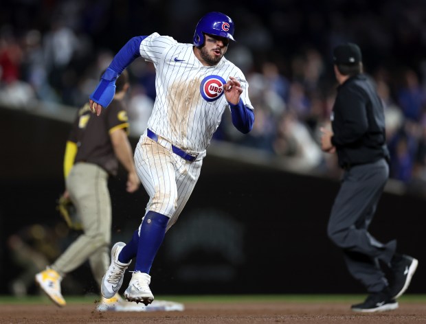 Chicago Cubs outfielder Mike Tauchman (40) advances to third base on a single by teammate Cody Bellinger in the 8th inning of a game against the San Diego Padres at Wrigley Field in Chicago on May 7, 2024. (Chris Sweda/Chicago Tribune)