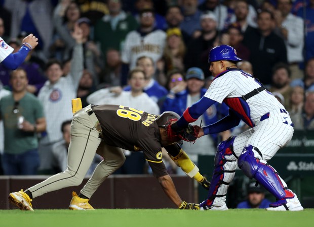 Chicago Cubs catcher Miguel Amaya (9) tags out San Diego Padres baserunner José Azocar (28) during a rundown to end the top of the seventh inning of a game at Wrigley Field in Chicago on May 7, 2024. (Chris Sweda/Chicago Tribune)