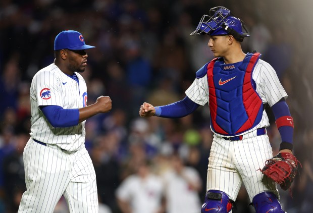 Chicago Cubs pitcher Héctor Neris (51) and catcher Miguel Amaya (9) congratulate one another after shutting down the San Diego Padres in the ninth inning of a game at Wrigley Field in Chicago on May 7, 2024. (Chris Sweda/Chicago Tribune)