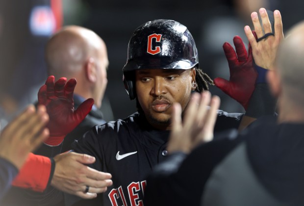Cleveland Guardians third baseman José Ramírez (11) is congratulated by his teammates in the dugout after hitting a solo home run in the 8th inning of a game against the Chicago White Sox at Guaranteed Rate Field in Chicago on May 9, 2024. (Chris Sweda/Chicago Tribune)