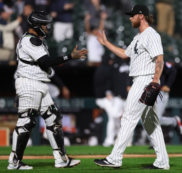 Chicago White Sox catcher Martín Maldonado (left) and relief pitcher Michael Kopech celebrate after a victory over the Cleveland Guardians at Guaranteed Rate Field in Chicago on May 9, 2024. (Chris Sweda/Chicago Tribune)