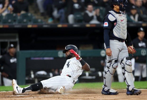 White Sox third baseman Bryan Ramos slides in safely into home a Paul DeJong single in the second inning against the Guardians on May 9, 2024, at Guaranteed Rate Field. (Chris Sweda/Chicago Tribune)
