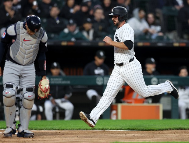 White Sox shortstop Paul DeJong crosses the plate on a Tommy Pham single in the second inning against the Guardians on May 9, 2024, at Guaranteed Rate Field. (Chris Sweda/Chicago Tribune)