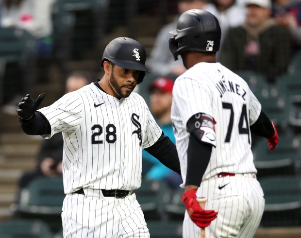 Chicago White Sox outfielder Tommy Pham (28) and designated hitter Eloy Jiménez (74) celebrate after Pham scored on a double by Andrew Vaughn in the first inning of a game against the Cleveland Guardians at Guaranteed Rate Field in Chicago on May 9, 2024. (Chris Sweda/Chicago Tribune)