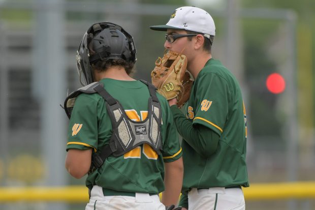 Waubonsie Valley's catcher Shane Torres (25) and pitcher Ryan Morton (5) talk at the mound during DuPage Valley Conference Tournament championship against the Naperville Central on Thursday, May 16, 2024. (Mark Black / Naperville Sun)