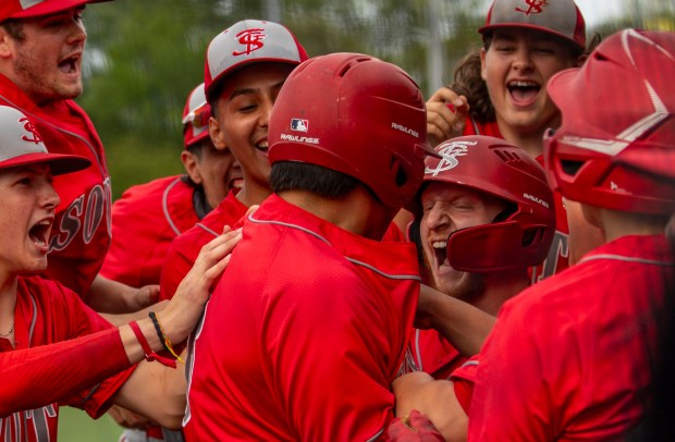 The Red Wolves cheer for Thornton Fractional South's Jack Starcevich (23), center right, after making a run against Evergreen Park High School during a game in Evergreen Park on Thursday, May 16, 2024. (Nate Swanson/for the Daily Southtown)