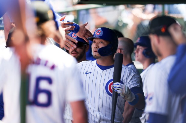 Chicago Cubs outfielder Seiya Suzuki celebrates with teammates after hitting a sacrifice fly to get outfielder Mike Tauchman home during the third inning against the Pittsburgh Pirates at Wrigley Field on May 19, 2024. (Eileen T. Meslar/Chicago Tribune)