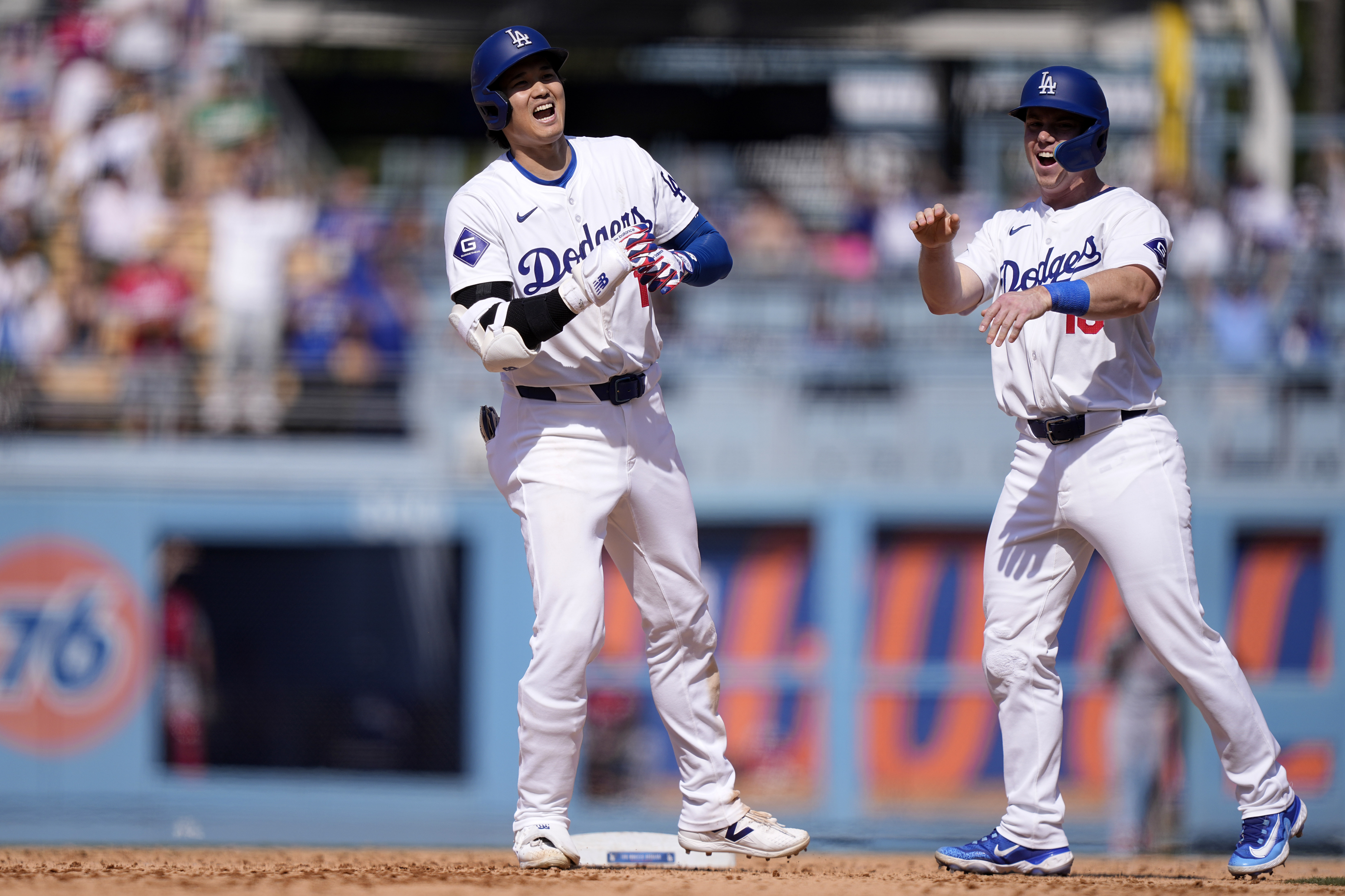 Los Angeles Dodgers’ Shohei Ohtani, left, is congratulated by Will...