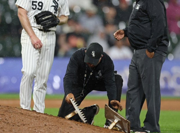 A grounds crew worker replaces a cleat cleaner for White Sox pitcher John Brebbia (59) due to excess mud in the eighth inning against the Orioles at Guaranteed Rate Field on May 24, 2024, in Chicago. (John J. Kim/Chicago Tribune)