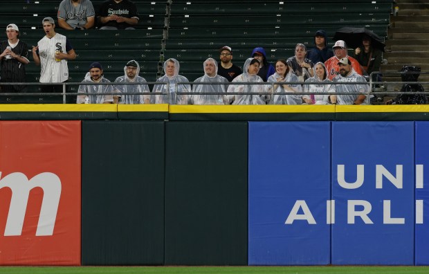 Fans wear ponchos in the bleachers during a steady rain in the eighth inning between the White Sox and Orioles at Guaranteed Rate Field on May 24, 2024, in Chicago. (John J. Kim/Chicago Tribune)