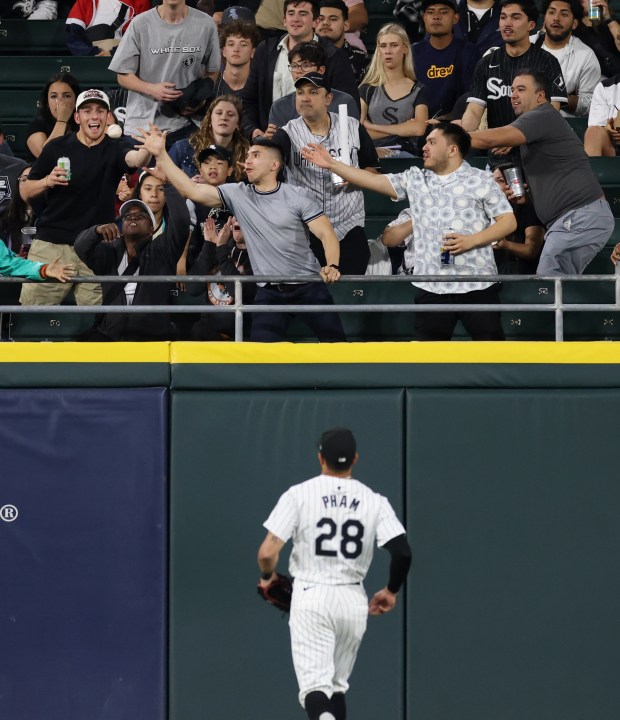 Fans reach for an RBI ground rule double hit by Orioles first baseman Ryan Mountcastle in the fifth inning against the White Sox at Guaranteed Rate Field on May 24, 2024, in Chicago. (John J. Kim/Chicago Tribune)