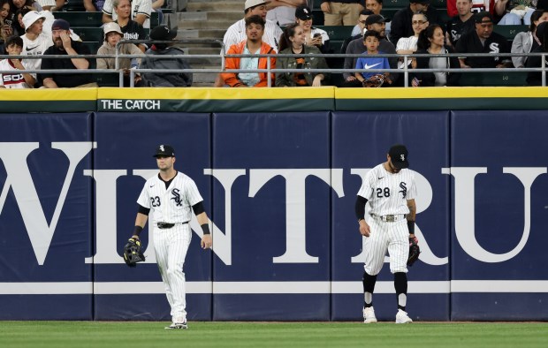 White Sox left fielder Andrew Benintendi (23), left, and centerfielder Tommy Pham (28) head back to their positions after an RBI ground rule double hit by Orioles first baseman Ryan Mountcastle in the fifth inning at Guaranteed Rate Field on May 24, 2024, in Chicago. (John J. Kim/Chicago Tribune)