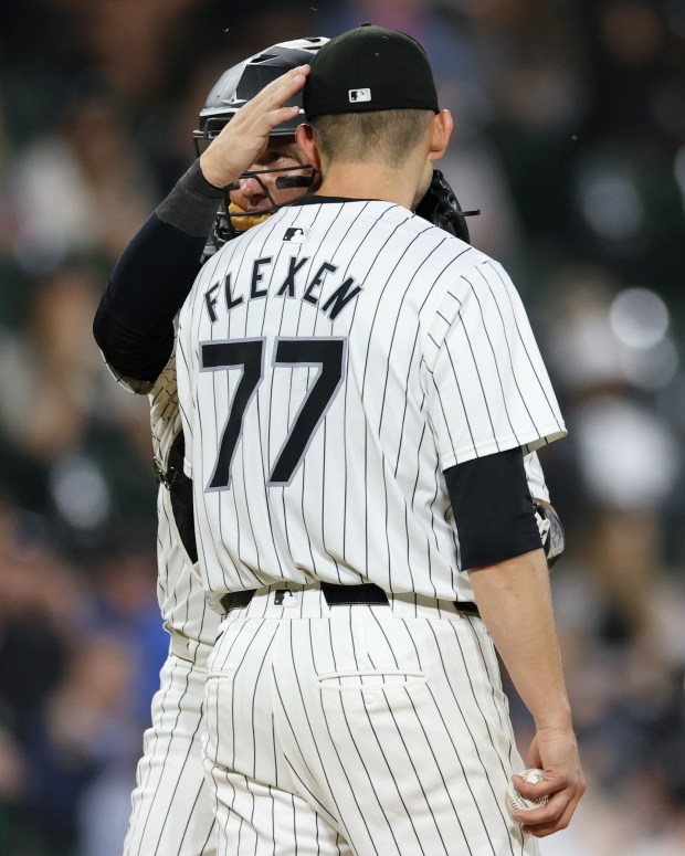 White Sox catcher Korey Lee (26), left, has an up-close talk with pitcher Chris Flexen (77) on the mound in the fifth inning against the Orioles at Guaranteed Rate Field on May 24, 2024, in Chicago. (John J. Kim/Chicago Tribune)