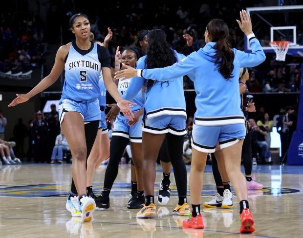 Chicago Sky forward Angel Reese (left) and her teammates celebrate in the first half of the Sky's home opener against the Connecticut Sun at Wintrust Arena in Chicago on May 25, 2024. (Chris Sweda/Chicago Tribune)