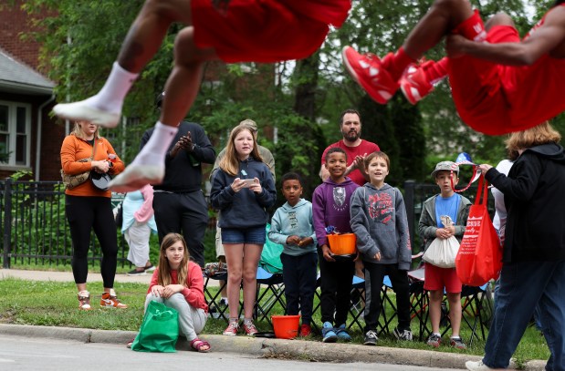 People watch The Jesse White Tumblers perform during the Beverly/Morgan Park Memorial Day parade on May 27, 2024. (Eileen T. Meslar/Chicago Tribune)