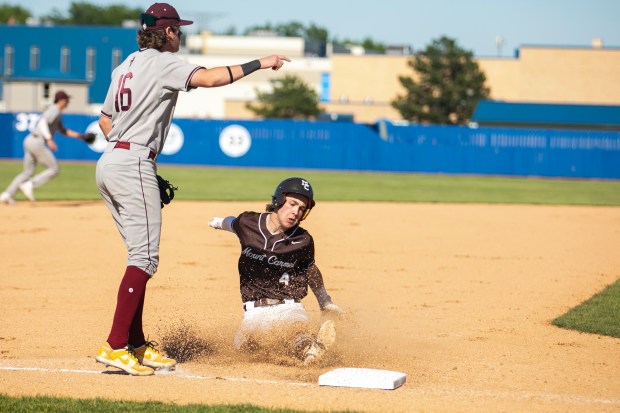 Mount Carmel's Timmy Harrigan (4) slides into third against Brother Rice during the Class 4A Reavis Sectional semifinal in Burbank on Wednesday, May 29, 2024. (Vincent D. Johnson/for the Daily Southtown)