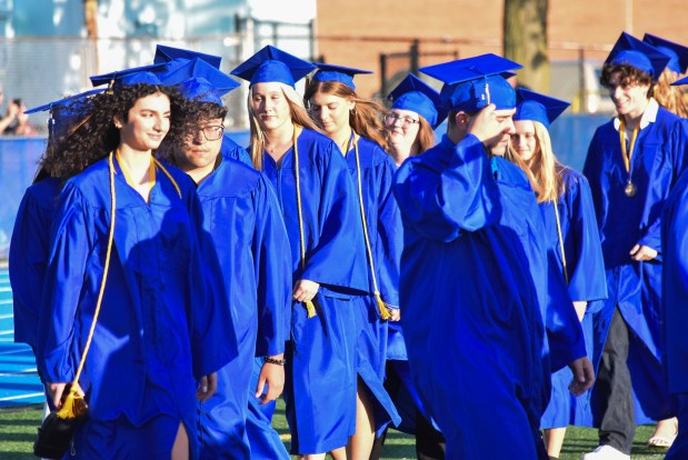 Lyons Township High School graduates walk together, possibly for the last time, before their graduation on Wednesday, May 29. (Jesse Wright)