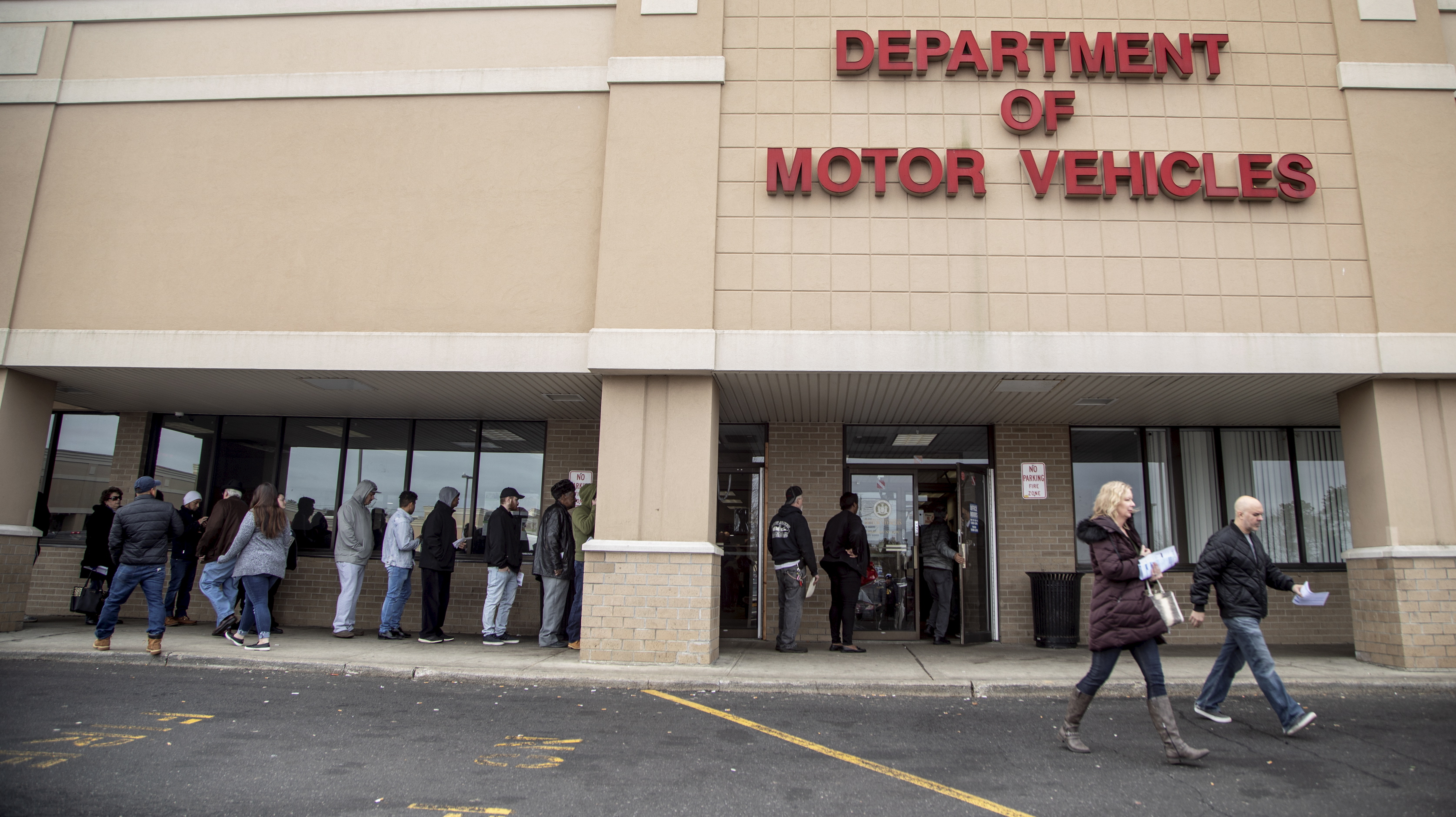 People line up waiting outside of the New York State Department of Motor Vehicles office in Medford, N.Y. on Long Island.