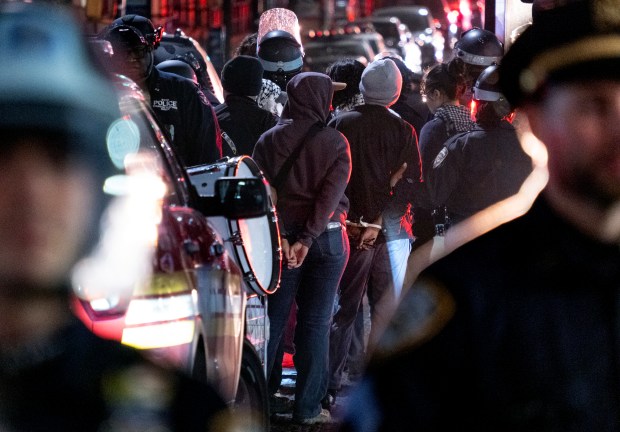 New York City police officers take people into custody near the Columbia University campus in New York on April 30, 2024, after a building taken over by protesters earlier in the day was cleared, along with a tent encampment. (Craig Ruttle/AP)