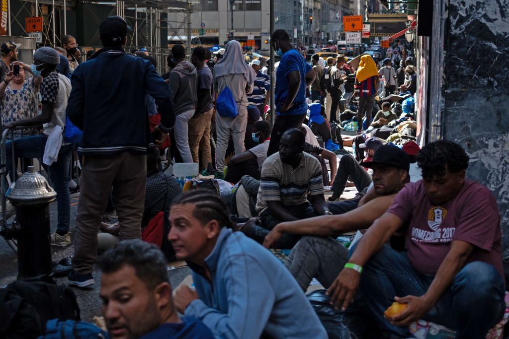 Migrants gather outside of the Roosevelt Hotel in Manhattan awaiting processing  on Aug. 2, 2023.