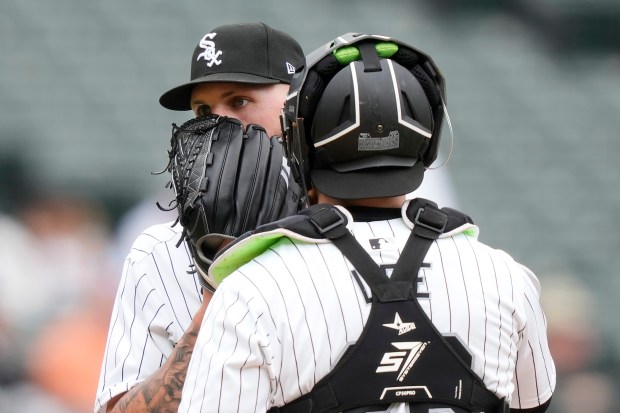 Chicago White Sox pitcher Garrett Crochet, left, talks with catcher Korey Lee, right, on the mound during the fourth inning of a baseball game against the Baltimore Orioles, Sunday, May 26, 2024, in Chicago. (AP Photo/Charles Rex Arbogast)