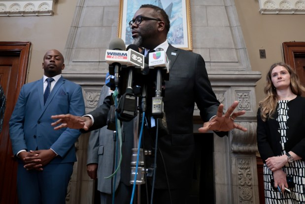 Mayor Brandon Johnson speaks with reporters following the announcement of the People's Plan for Community Safety during a press conference at the Garfield Park field house in Chicago on March 13, 2024. Deputy Mayor of Community Safety Garien Gatewood is on left. (Antonio Perez/Chicago Tribune)