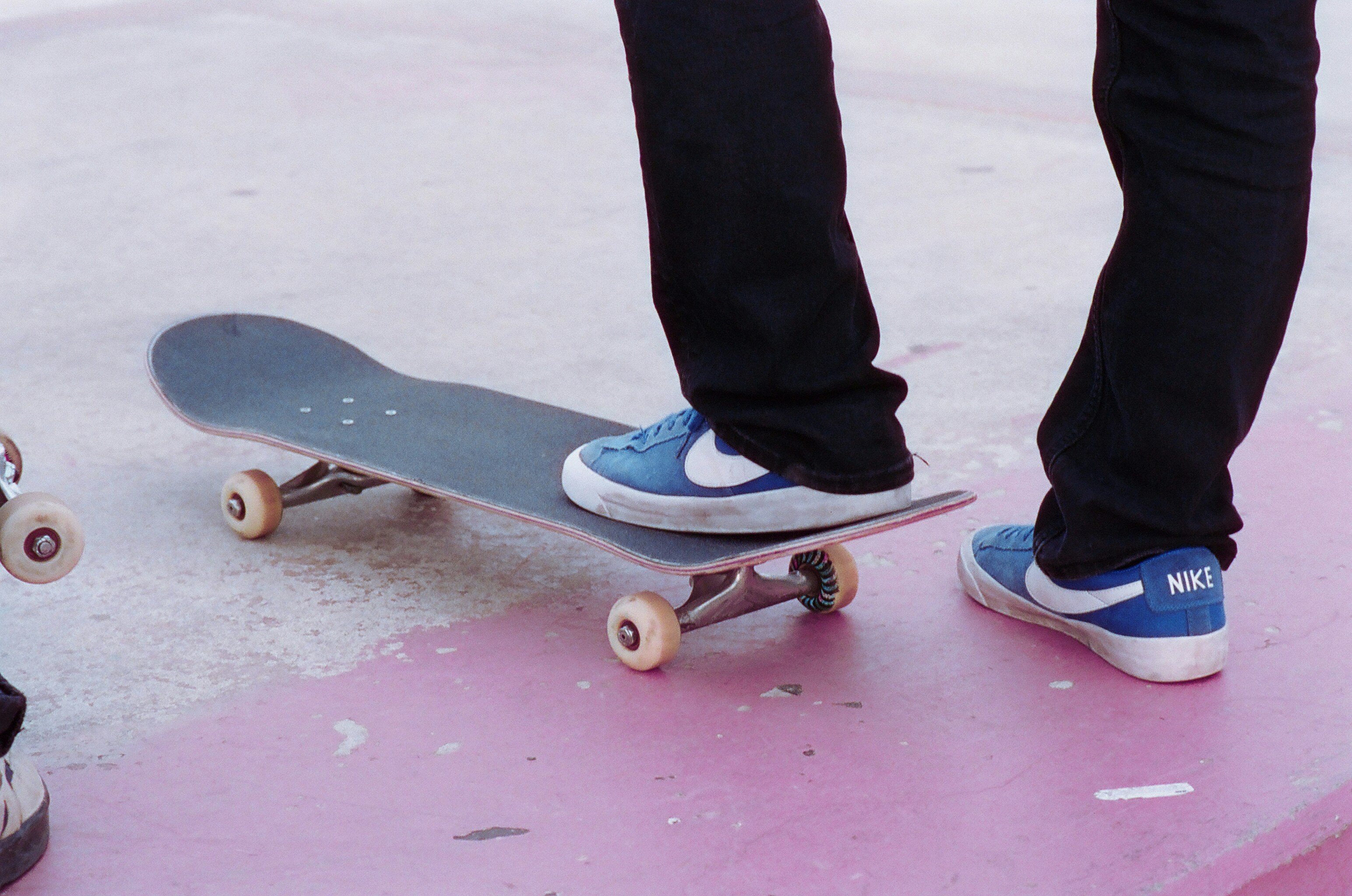 A person's feet on a skateboard.