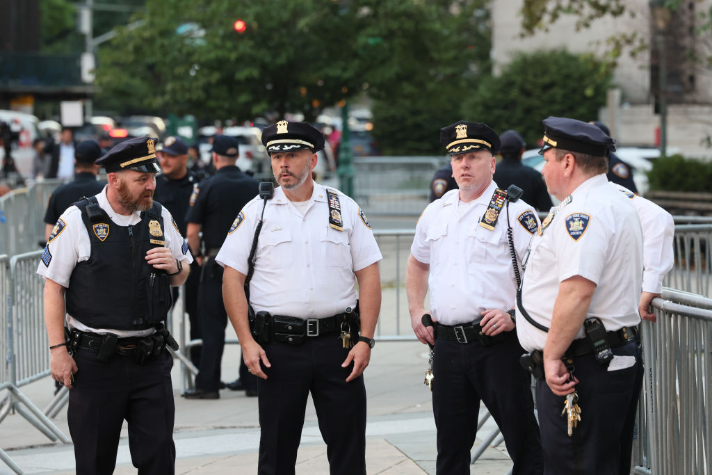 four cops standing outside the courthouse