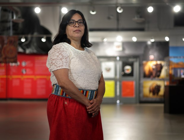 Gina Roxas, executive director of Trickster Cultural Center, stands in the gallery on May 1, 2024, in Schaumburg. She is a member of the Prairie Band Potawatomi Nation. (Stacey Wescott/Chicago Tribune)