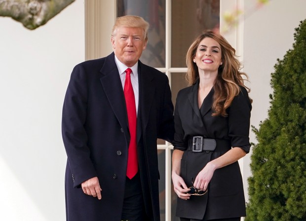 President Donald Trump poses for members of the media with then White House Communications Director Hope Hicks on her last day before he boards Marine One on the South Lawn of the White House, March 29, 2018, in Washington.