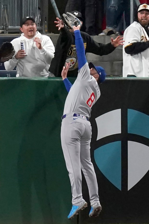 Cubs left fielder Ian Happ robs the Pirates' Andrew McCutchen of a home run with a catch over the wall during the ninth inning on May 10, 2024, in Pittsburgh. (Matt Freed/AP)